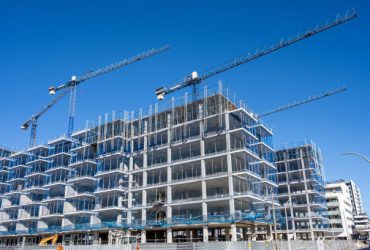 Construction site with cranes for residential buildings seen in Barcelona, Spain